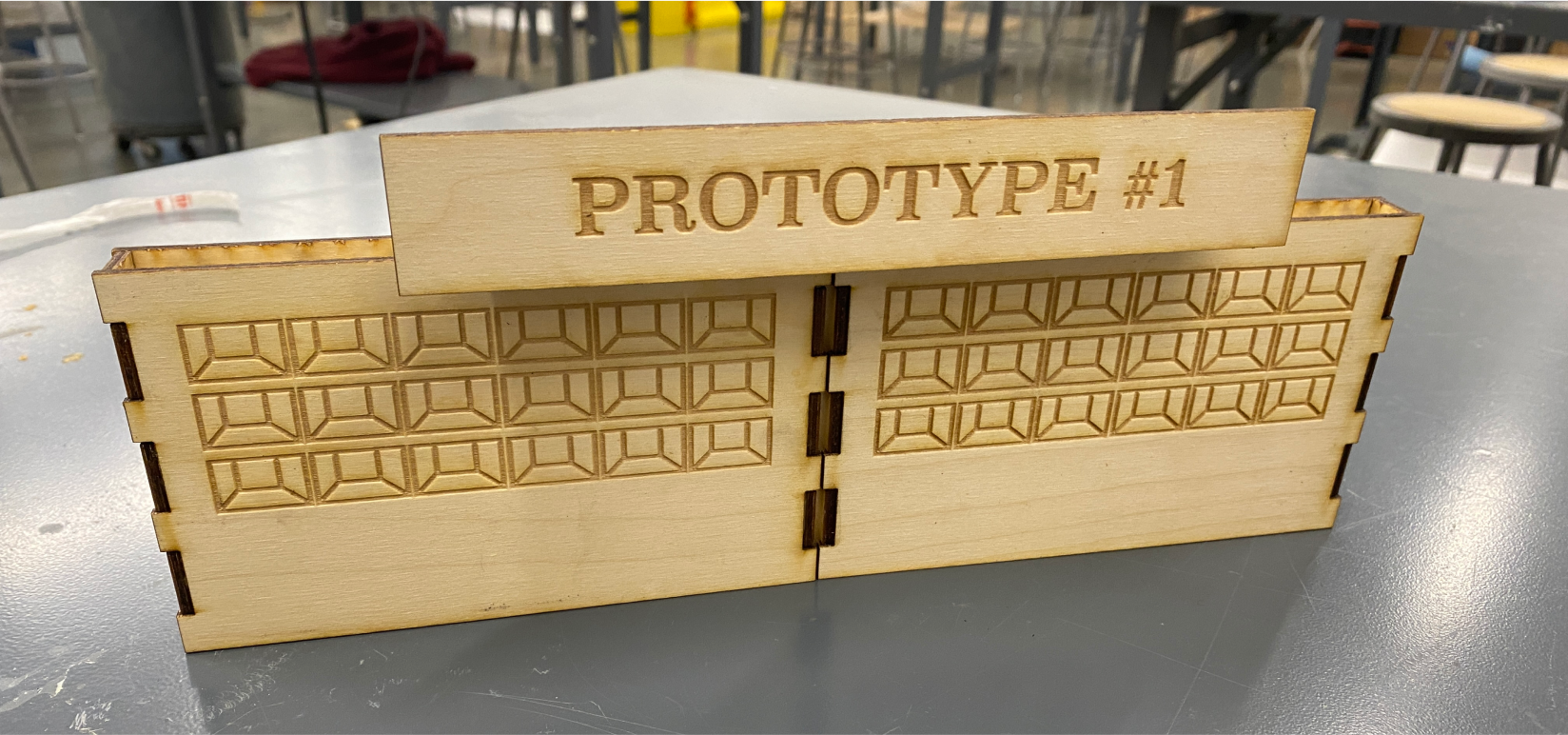 A wooden mini-mockup of the food stand, with lockers facing the festival-goers.